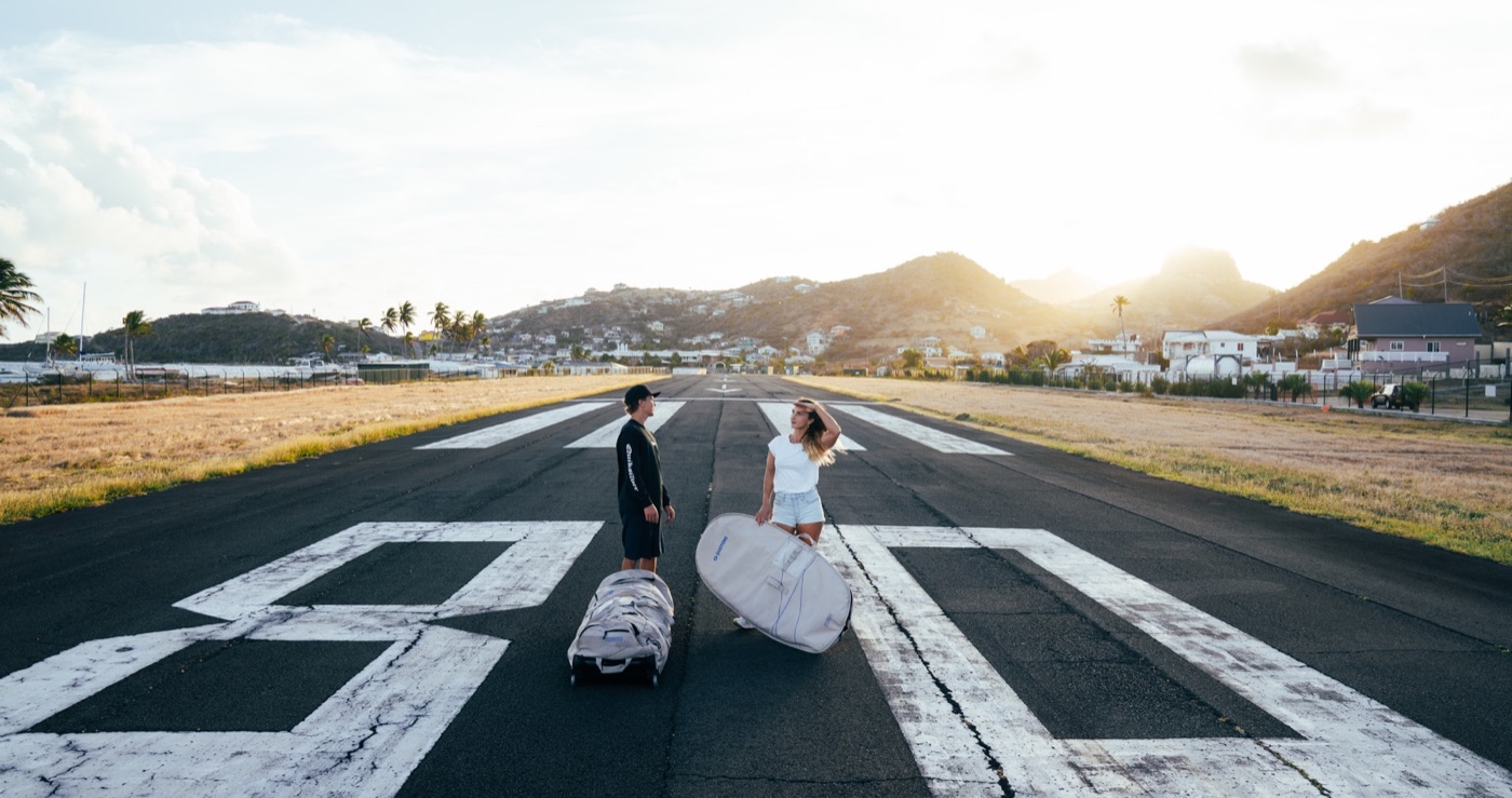 Travelers with kitesurf board bags arriving at Union Island Airport