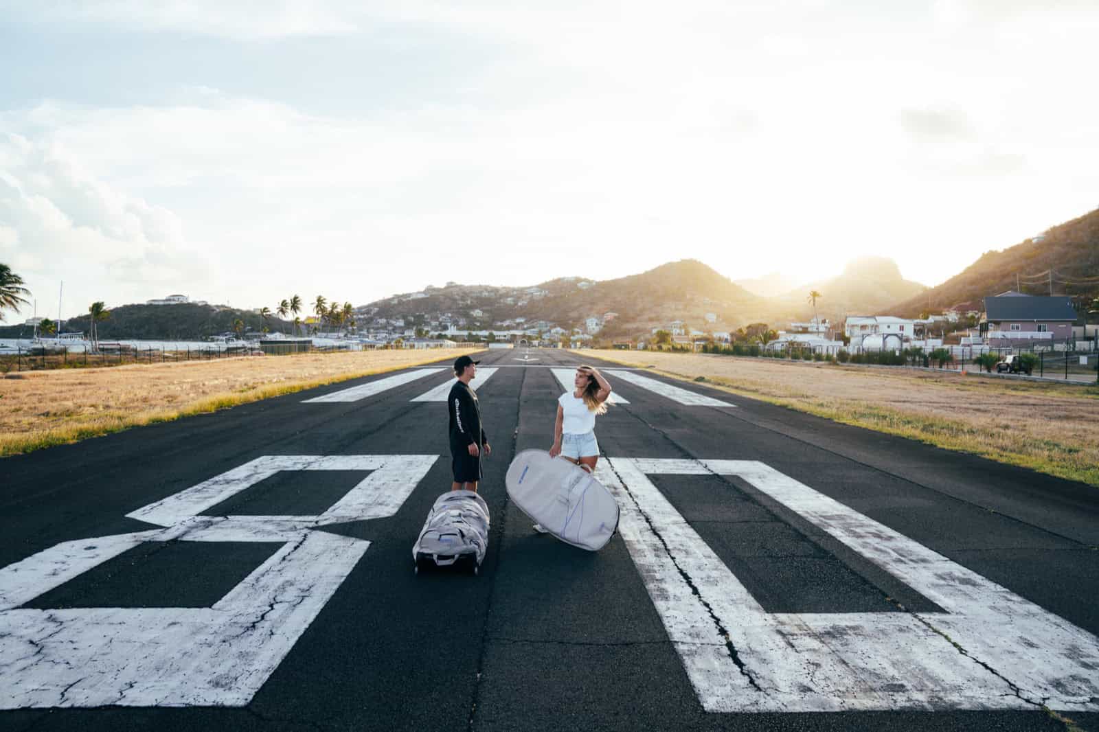 Travelers with kite bags on the Union Island Airport runway