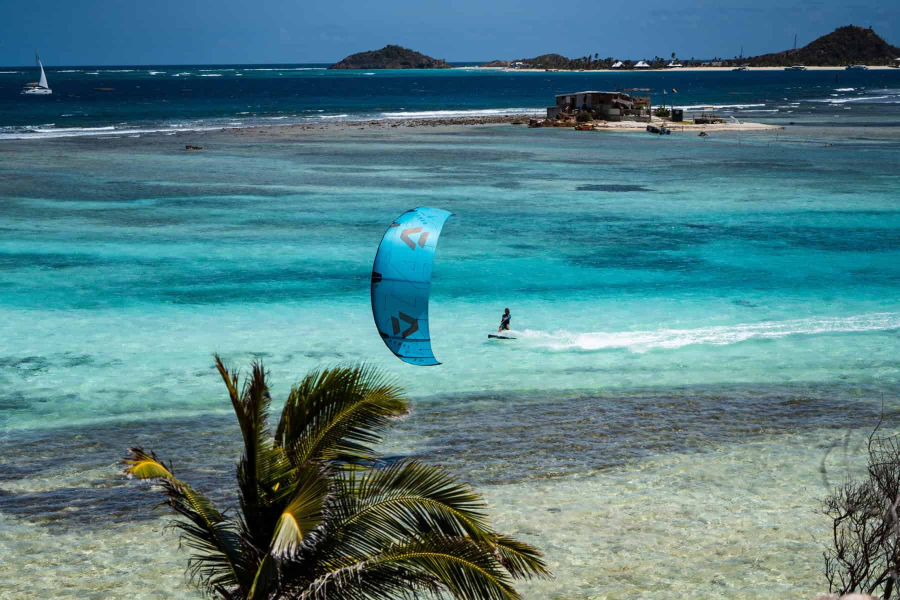 Kitesurfer riding near Union Island after beginner lessons