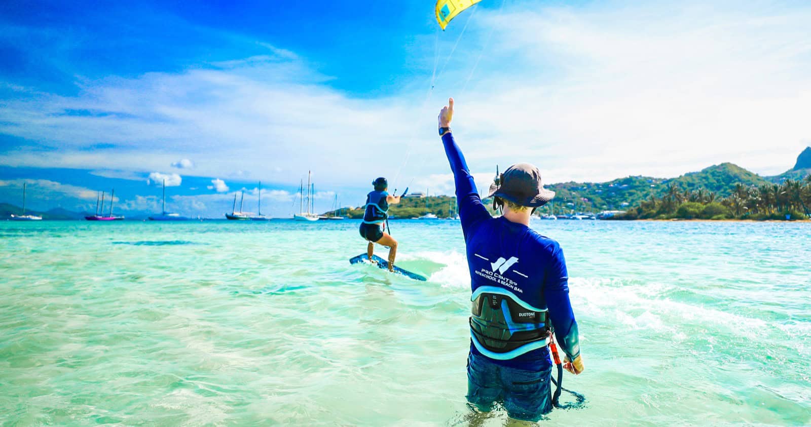 Beginner kitesurf student attempting a first water start on the board