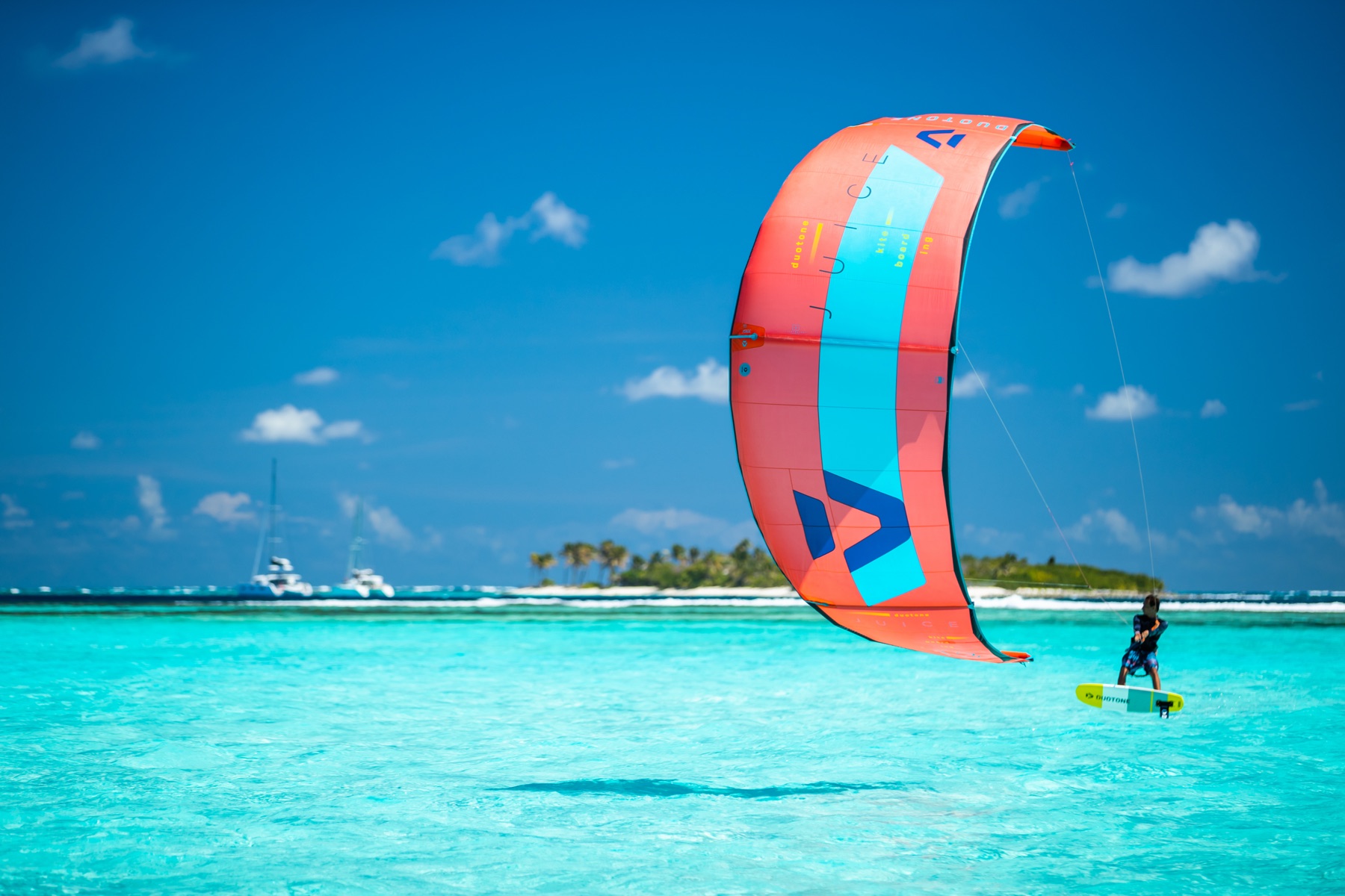 Kitesurfer riding turquoise water in Tobago Cays on a Grenadines kite trip
