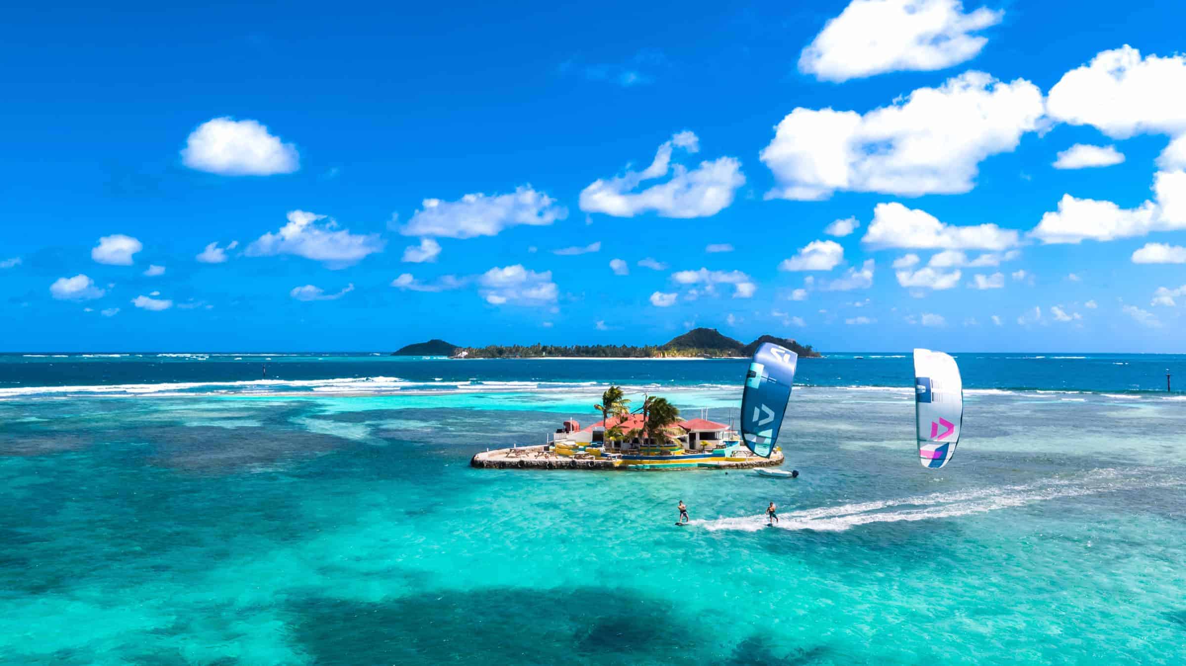 Kitesurfing by Happy Island in clear Grenadines water