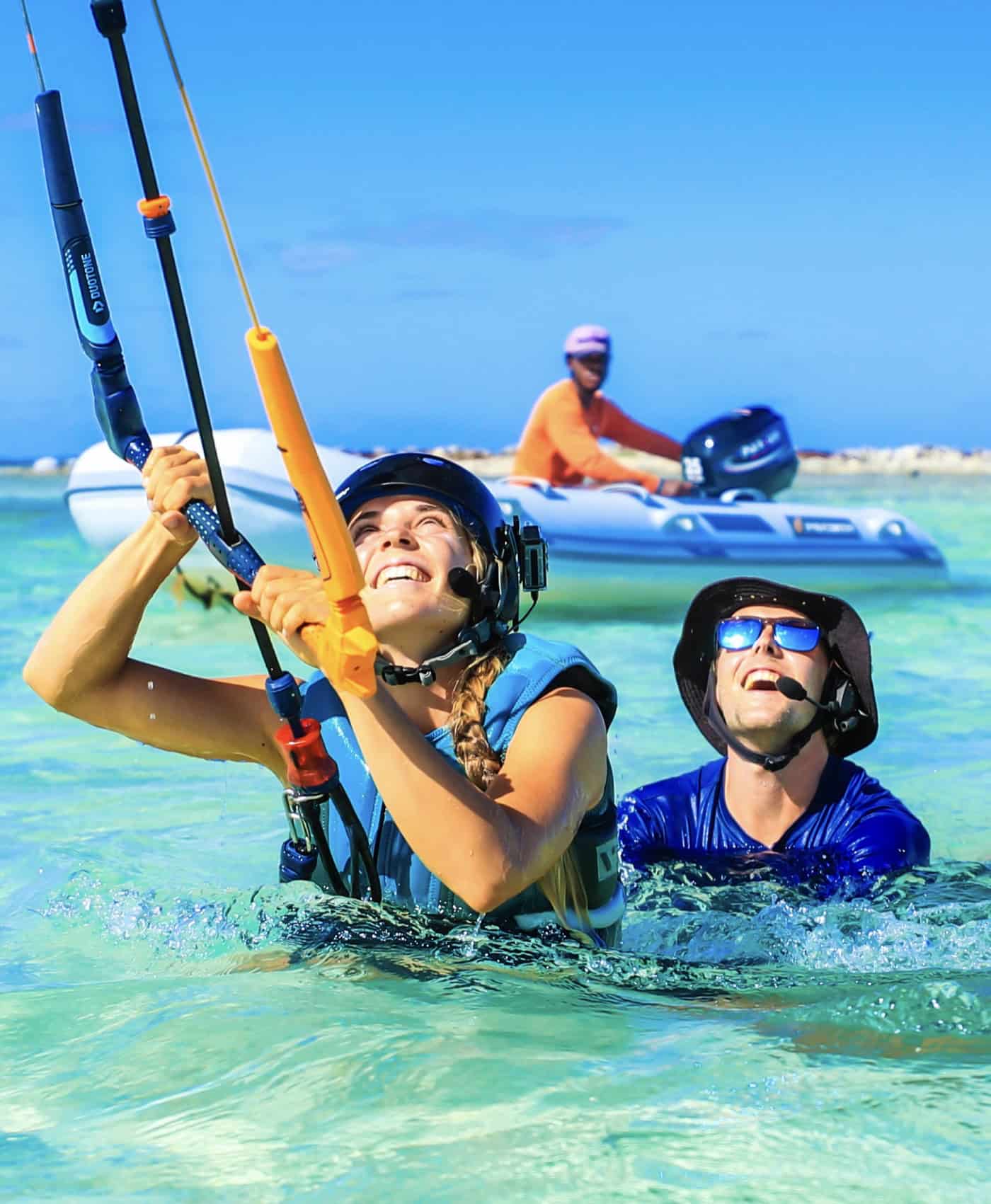 Private instructor and boat driver supporting a kitesurfing lesson from the water