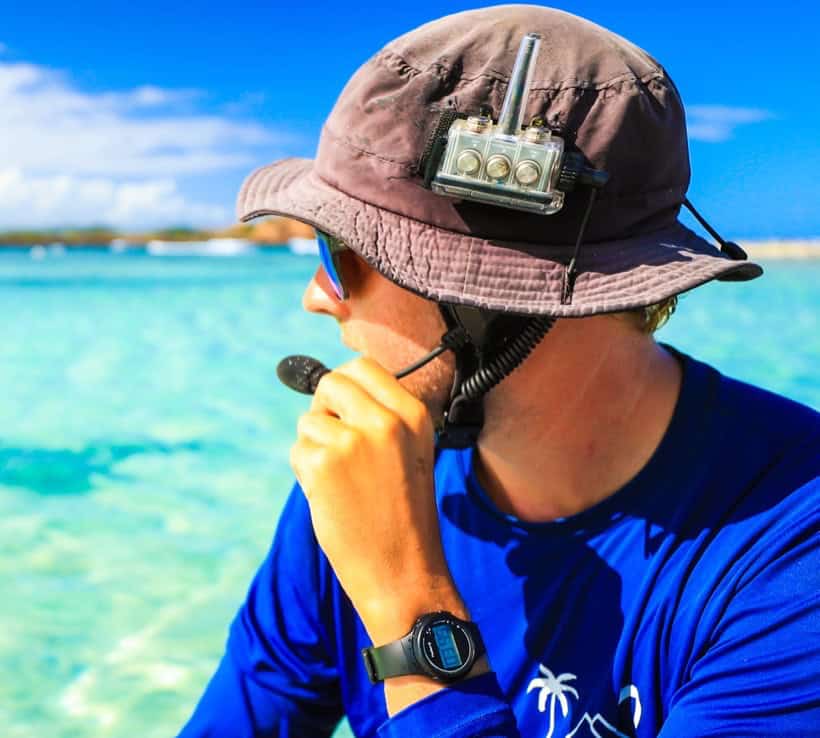 Experienced instructor giving radio assisted watersports coaching