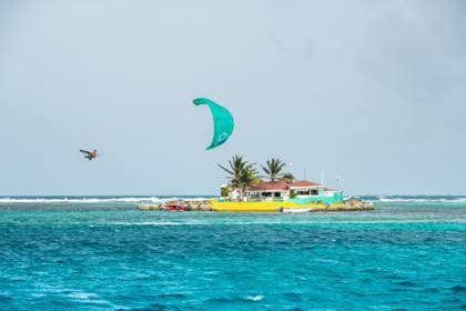 Kitesurfer riding near a Grenadines island for pro coaching