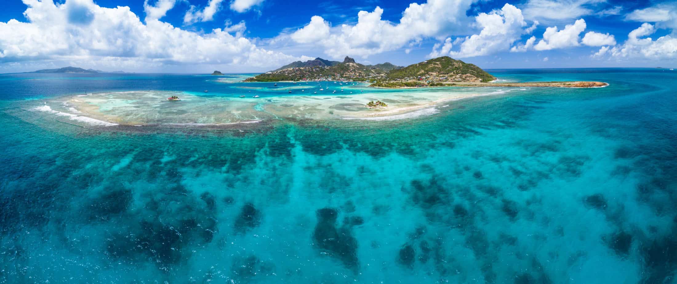 Wide aerial panorama of Union Island and the surrounding reef